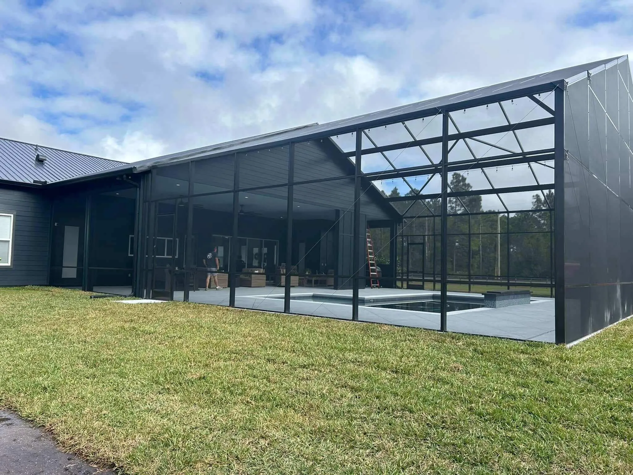professional crew installing aluminum pool enclosure frame