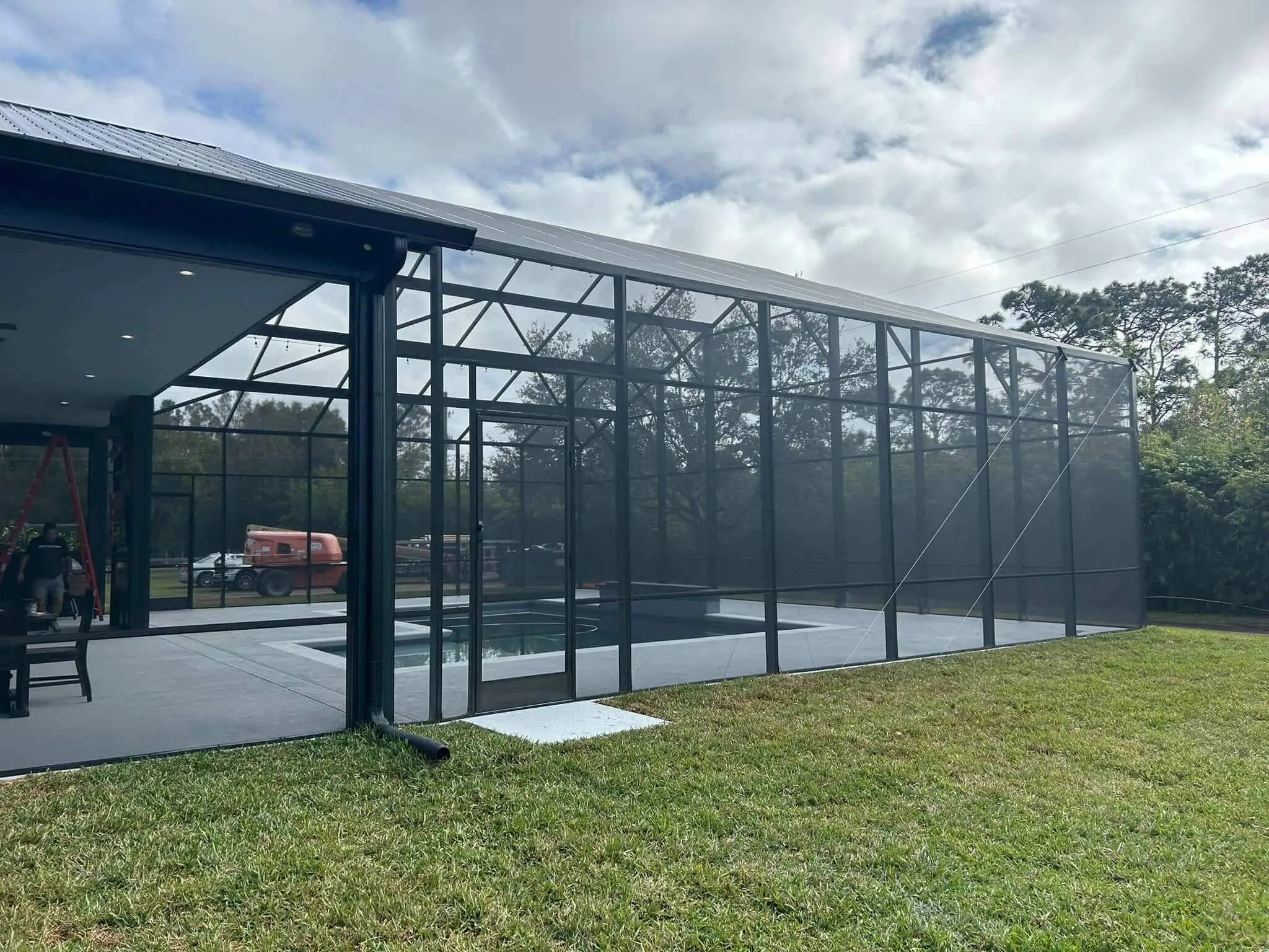 large outdoor screen enclosure structure installed beside modern house