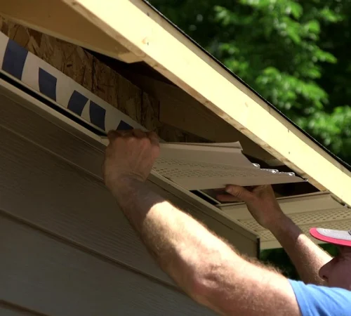 Soffit panel installation under roof eaves
