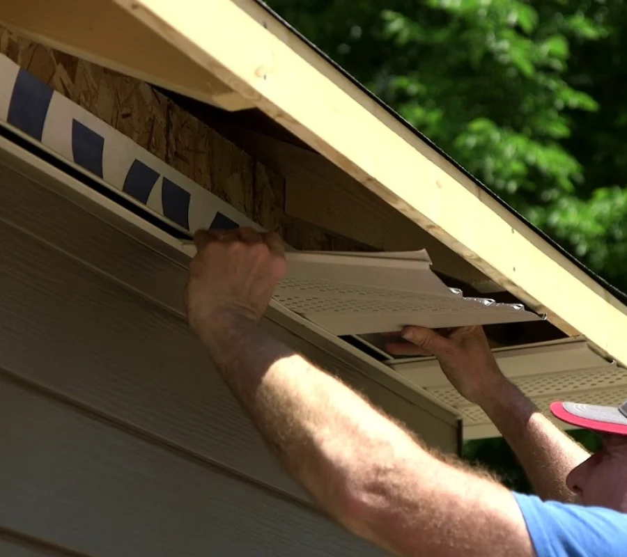 Soffit panel installation under roof eaves